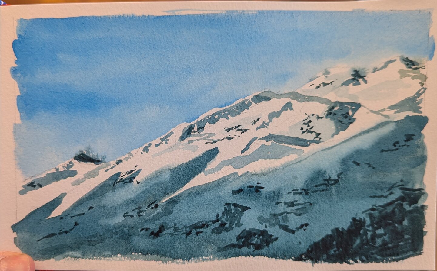 A snowy mountain in deep blues and grays.