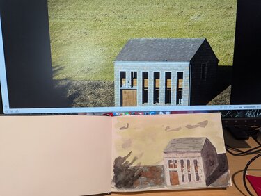 A gray building with windows sits in a deep valley. There are stark shadows against a bright green hillside behind the building.