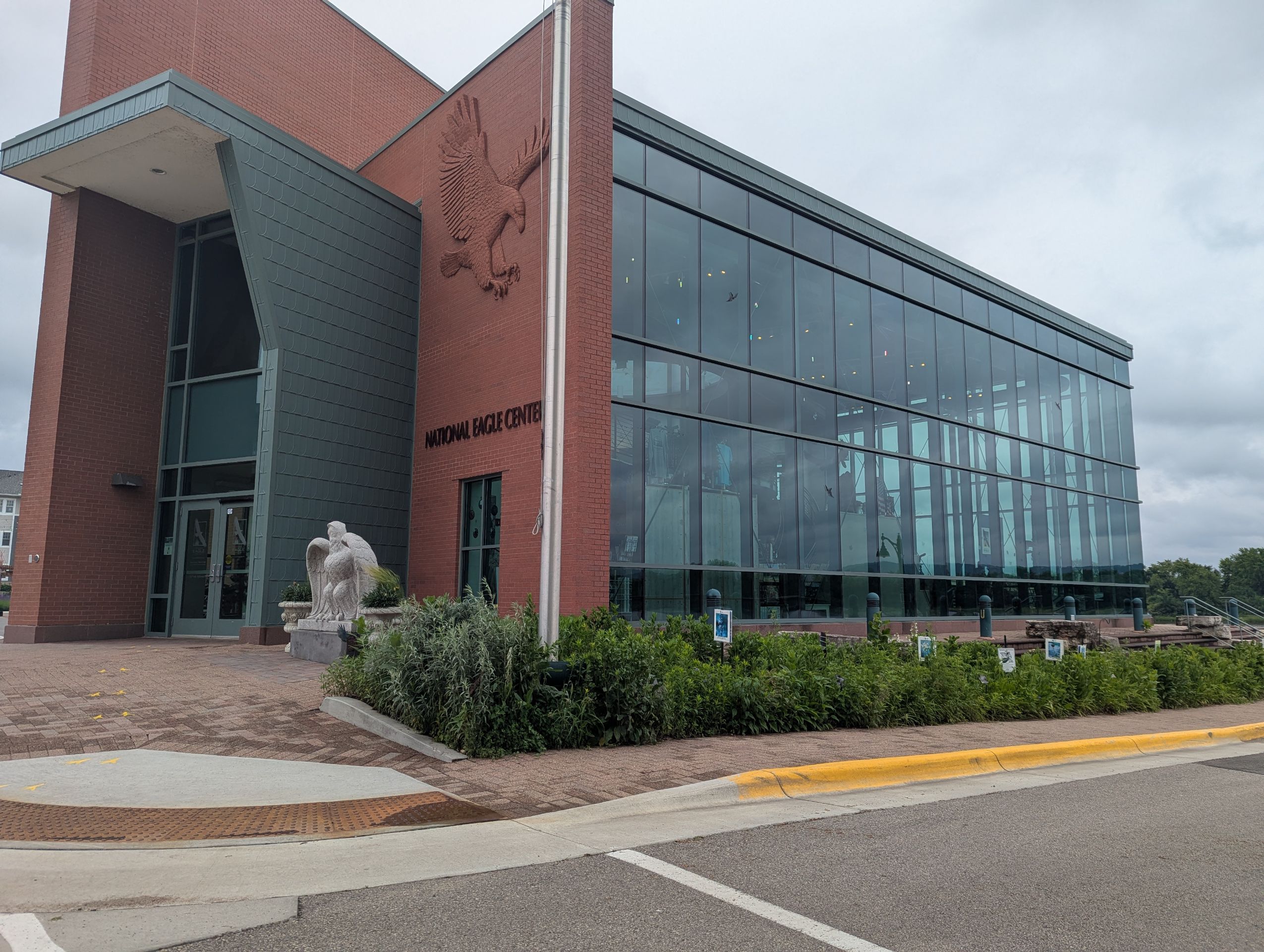 A red brick building with a large glass window.
