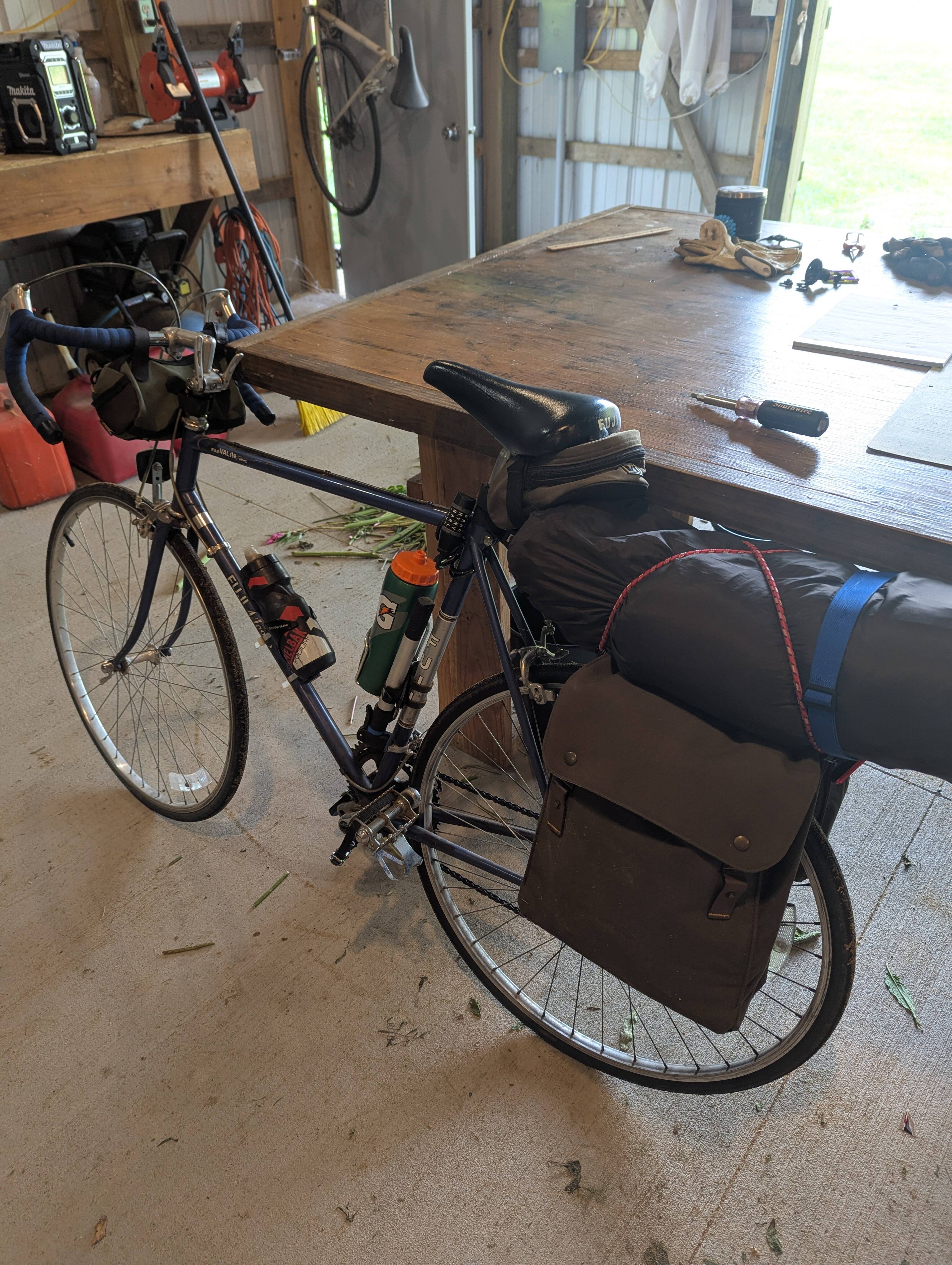 A bicycle loaded with gear on the rear rack.
